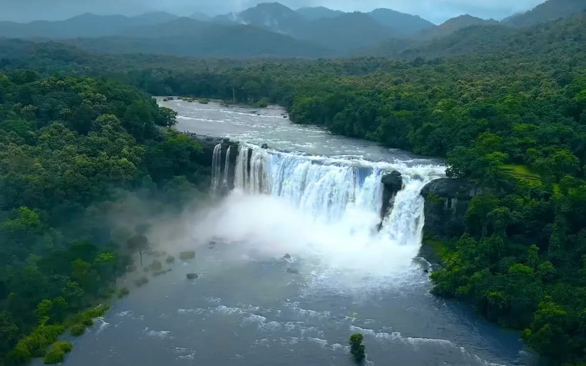 Wide Kerala waterfall in dense rainforest